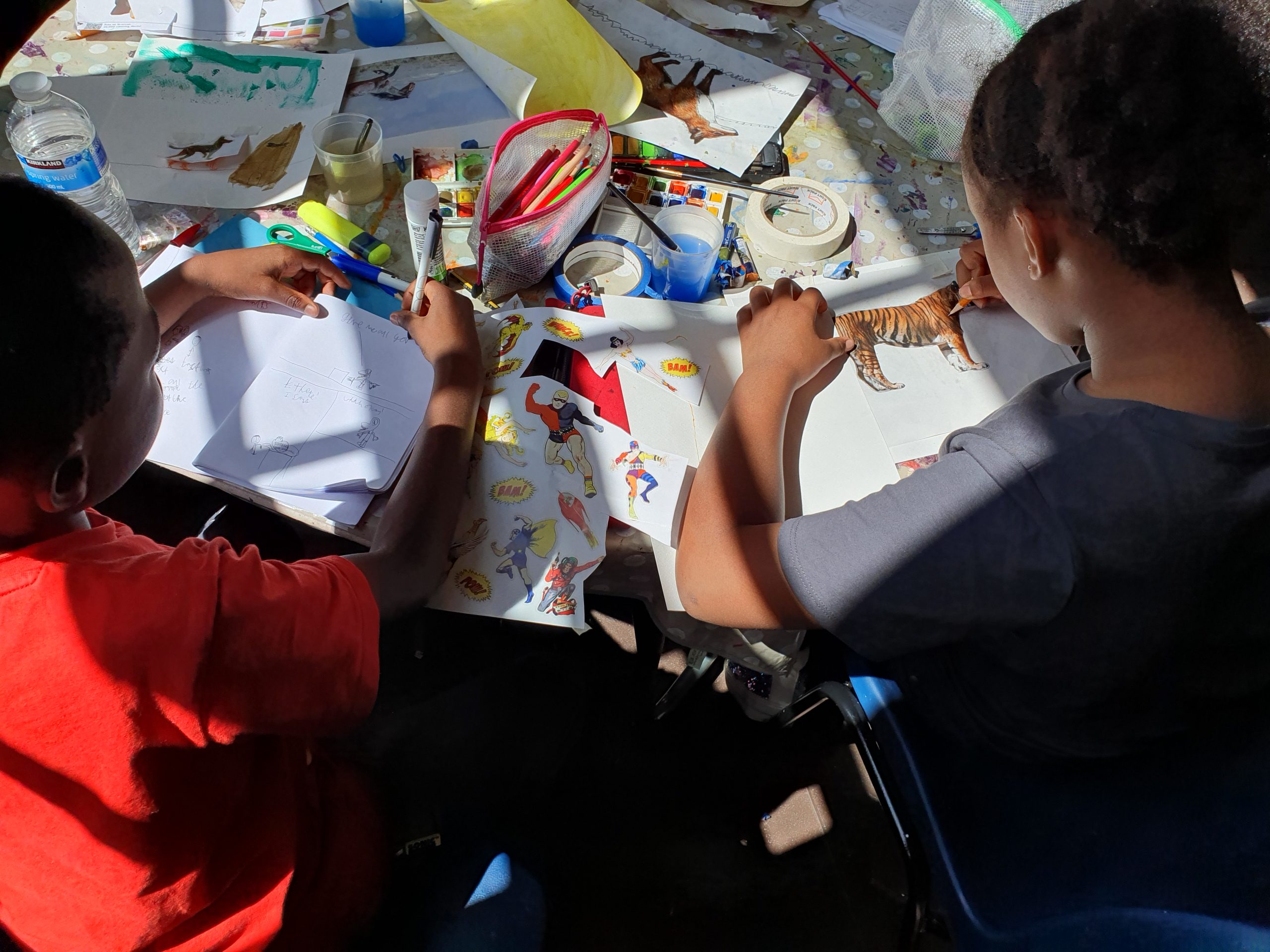 children painting in sunlight